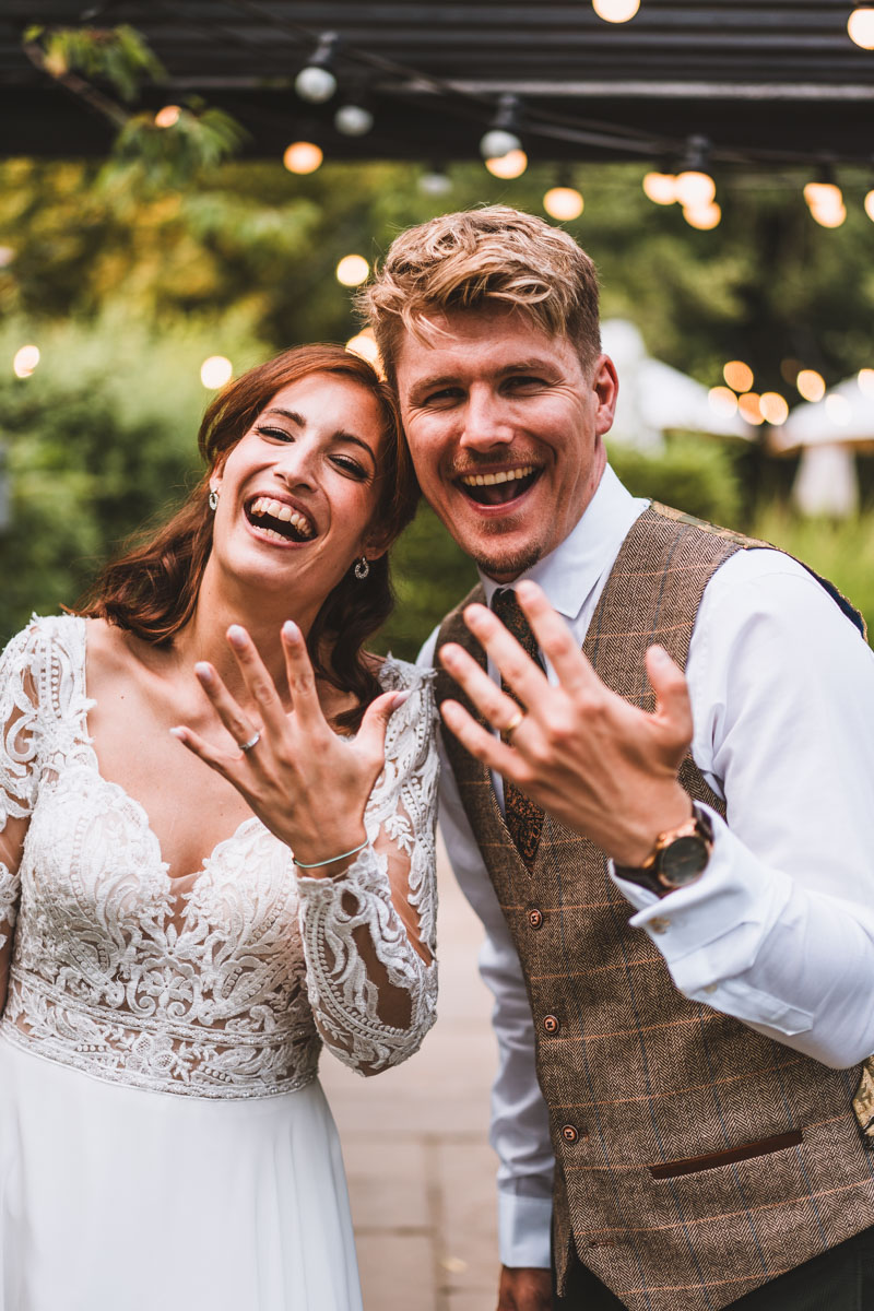 Wedding couple showing off their wedding rings