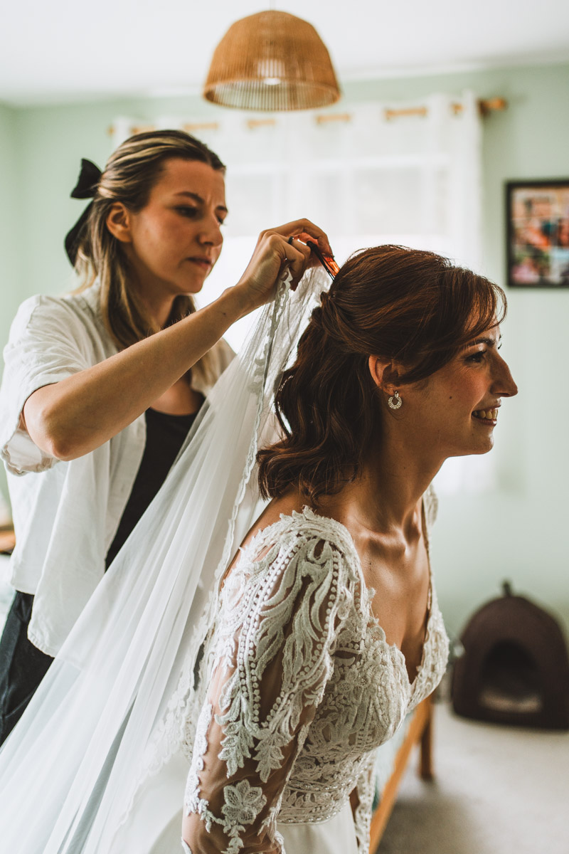 Full length wedding veil being pinned into place