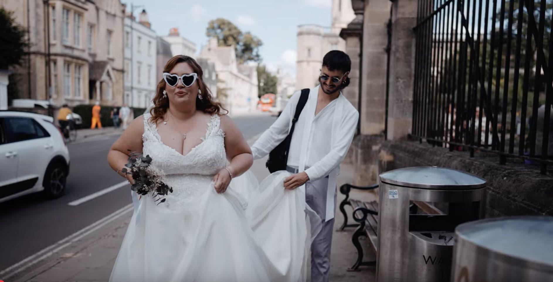 Bride and groom walking beside the colleges, before a Thames boat trip to the Isis Farmhouse wedding in Oxfordshire
