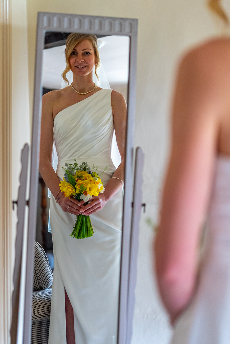 Bride having veil pinned into place at Akeman Inn wedding