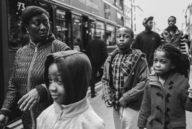 Family crossing Oxford Street in London