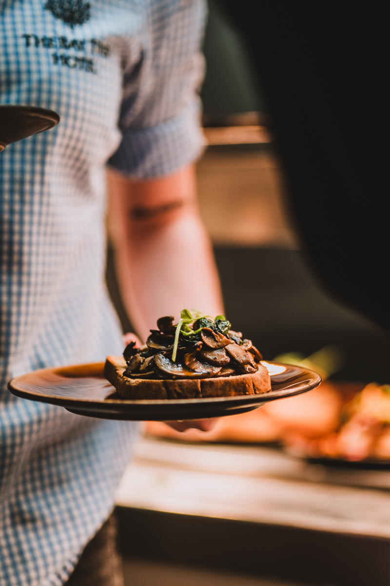Waitress serving guests during the wedding breakfast at an Oxfordshire wedding