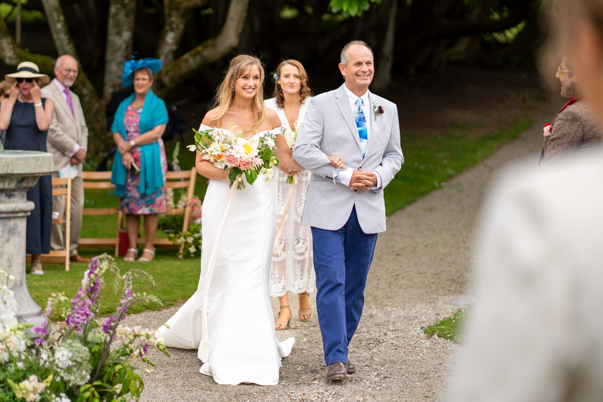 Proud emotional father of the bride walking his daughter down the aisle