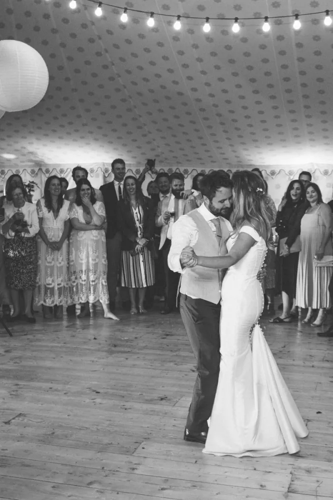 First dance as the wedding party looks on First dance as the wedding party looks on