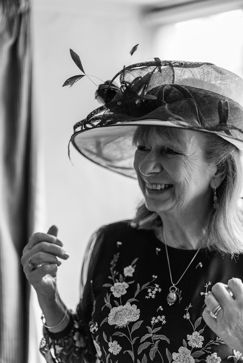 A candid moment of the mother of the bride laughing during a London city wedding, captured in a documentary style.