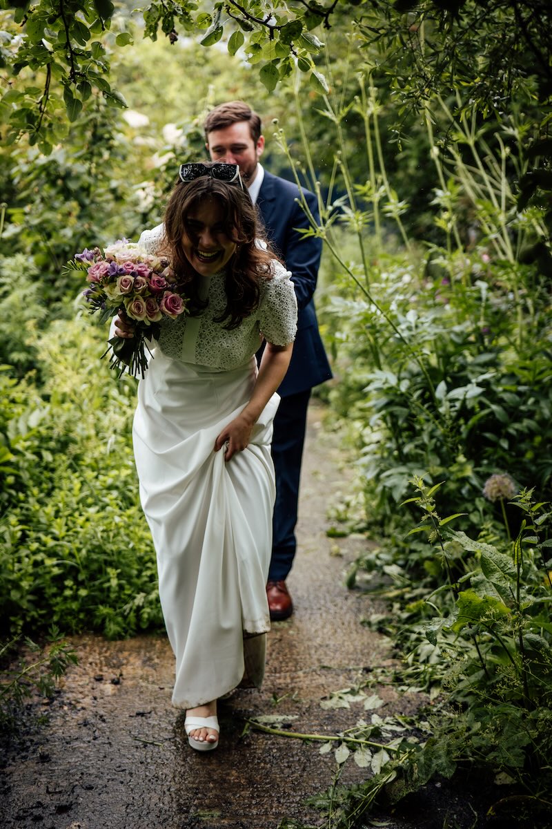 Roo laughing as she walks through the gardens with Rob at Worton Kitchen Garden